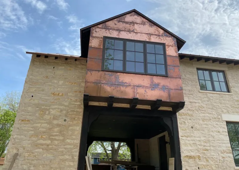 Copper metal panel facade on a stone building for Metal Roof Coating in Garrett